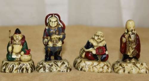A WONDERFUL SET OF SEVEN "JAPANESE SEVEN LUCKY GODS" HAND PAINTED & NUMBERED BAKELITE FIGURINES