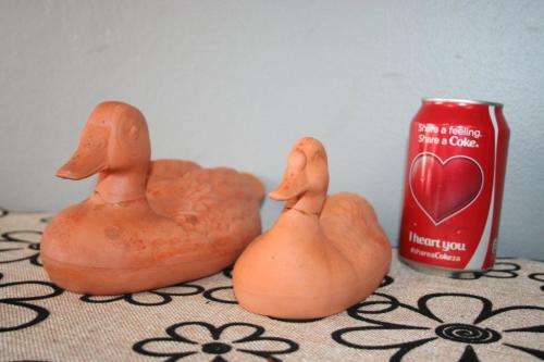 A gorgeous pair of terracotta stoneware ornamental ducks - perfect for the garden or pond