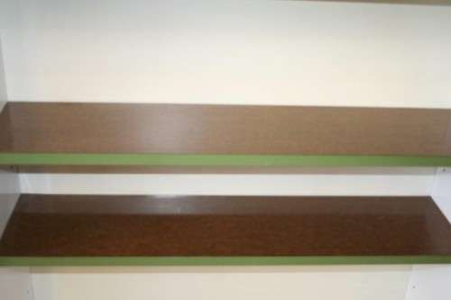 A GORGEOUS WHITE AND BROWN BOOK CASE WITH GREEN FACADES - PERFECT FOR A STUDY OR OFFICE