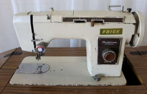 AN AMAZING VINTAGE (WORKING) "FRICK" SEWING MACHINE IN ITS ORIGINAL WOODEN CABINET