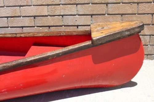 An incredible bright red rowing boat with a wooden oar in excellent condition | RS17