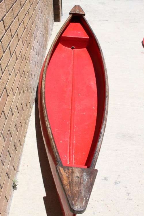 An incredible bright red rowing boat with a wooden oar in excellent condition | RS17