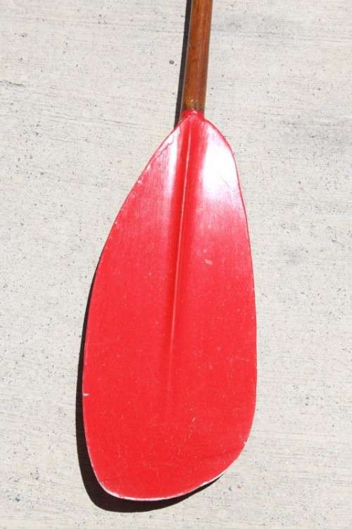 An incredible bright red rowing boat with a wooden oar in excellent condition | RS17
