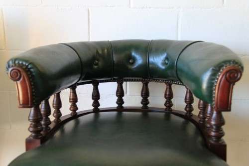 A spectacular solid mahogany "captain's swivel chair" with period British green upholstery