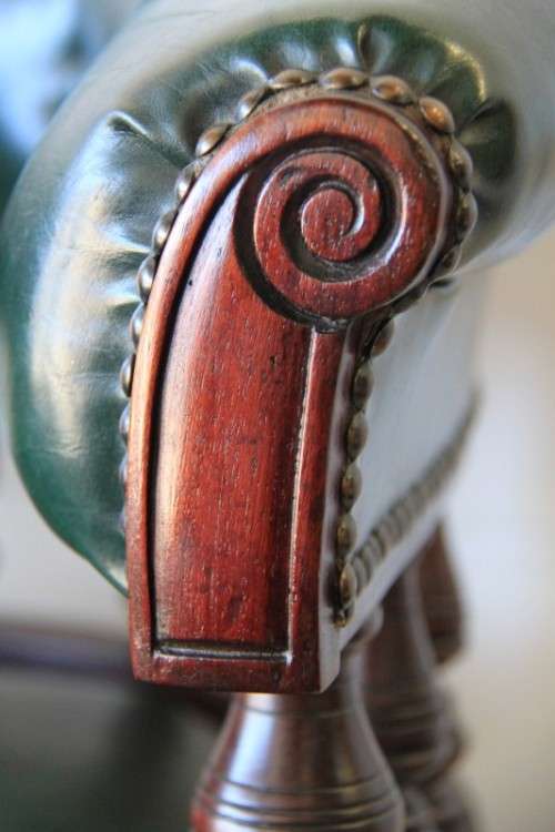 A spectacular solid mahogany "captain's swivel chair" with period British green upholstery