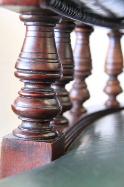 A spectacular solid mahogany "captain's swivel chair" with period British green upholstery