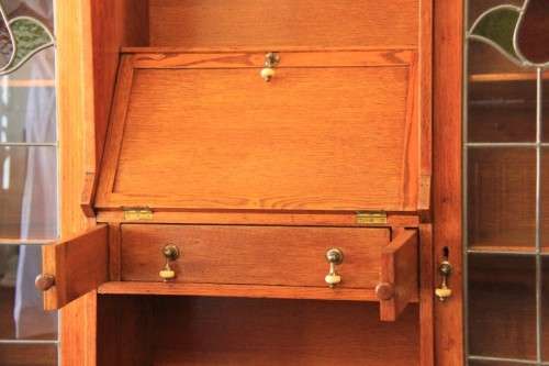 An awesome solid oak writing desk/ cabinet with incredible stained glass panels and ornate handles