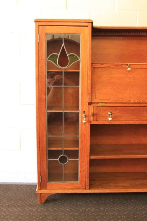 An awesome solid oak writing desk/ cabinet with incredible stained glass panels and ornate handles