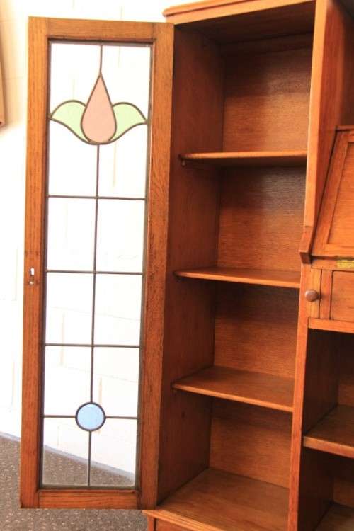 An awesome solid oak writing desk/ cabinet with incredible stained glass panels and ornate handles