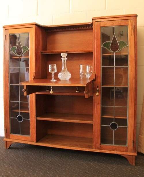 An awesome solid oak writing desk/ cabinet with incredible stained glass panels and ornate handles