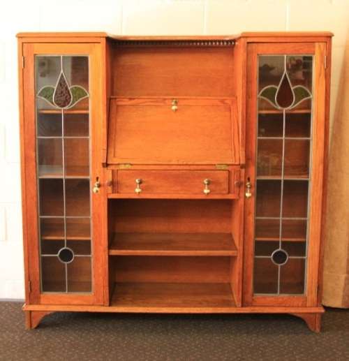 An awesome solid oak writing desk/ cabinet with incredible stained glass panels and ornate handles