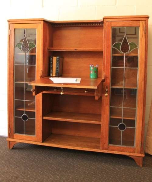 An awesome solid oak writing desk/ cabinet with incredible stained glass panels and ornate handles