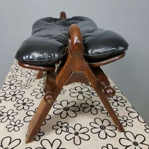 A wonderful vintage Moroccan "Camel Saddle" ottoman stool with stunning brass inlay detailing
