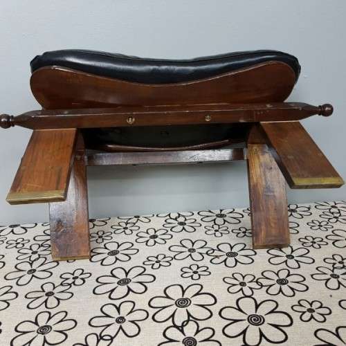 A wonderful vintage Moroccan "Camel Saddle" ottoman stool with stunning brass inlay detailing