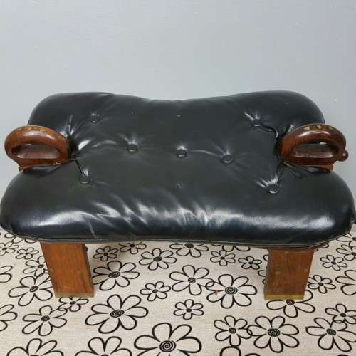 A wonderful vintage Moroccan "Camel Saddle" ottoman stool with stunning brass inlay detailing