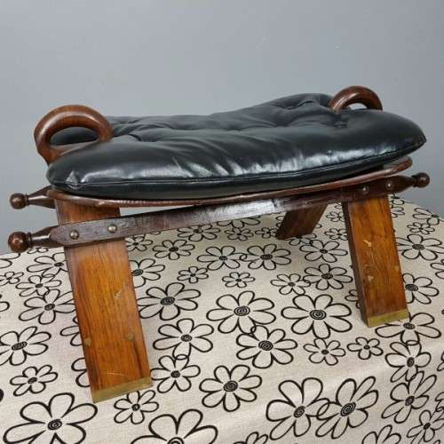 A wonderful vintage Moroccan "Camel Saddle" ottoman stool with stunning brass inlay detailing