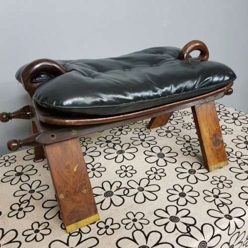 A wonderful vintage Moroccan "Camel Saddle" ottoman stool with stunning brass inlay detailing