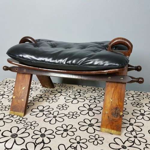 A wonderful vintage Moroccan "Camel Saddle" ottoman stool with stunning brass inlay detailing