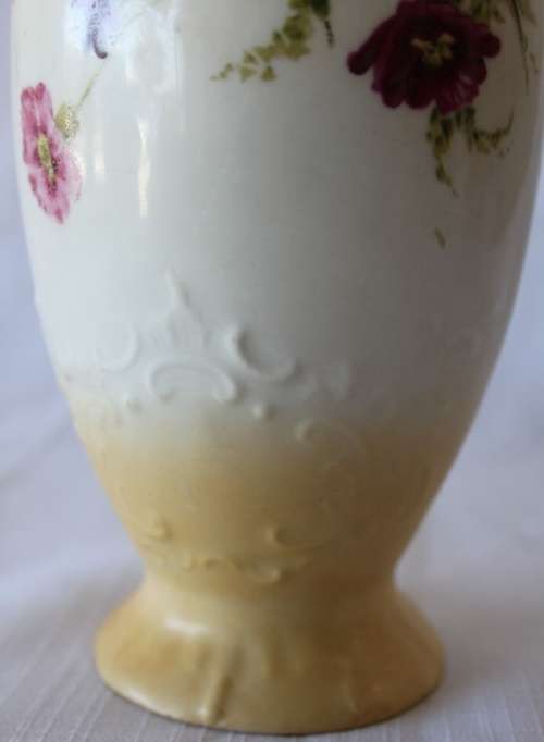 A gorgeous tall German-porcelain vase with scroll handles, flared rim and transfer print flowers
