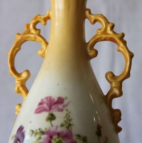 A gorgeous tall German-porcelain vase with scroll handles, flared rim and transfer print flowers