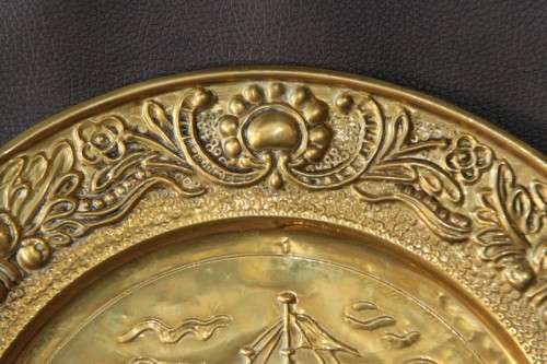 A lovely vintage brass wall plate with a hand-embossed "ship" detailing and a wall hook on the back