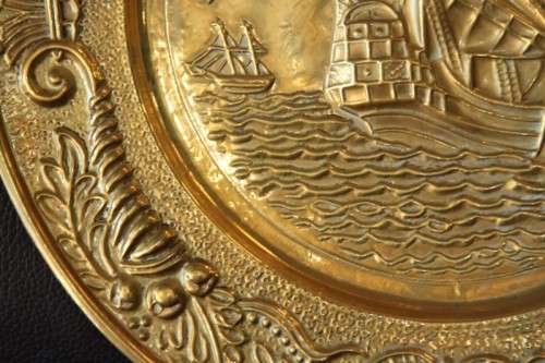 A lovely vintage brass wall plate with a hand-embossed "ship" detailing and a wall hook on the back