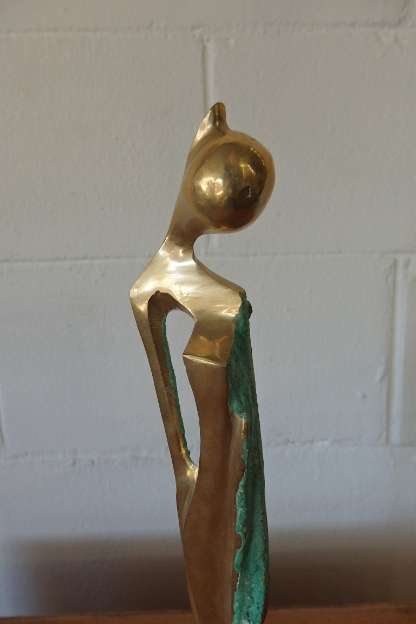 A wonderful tall solid brass abstract figurine mounted on a wooden base in great condition