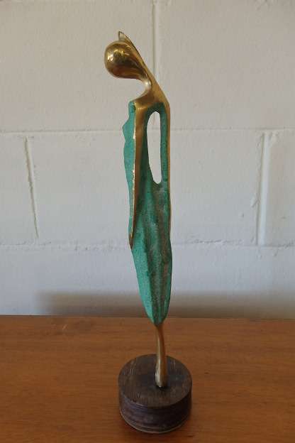 A wonderful tall solid brass abstract figurine mounted on a wooden base in great condition