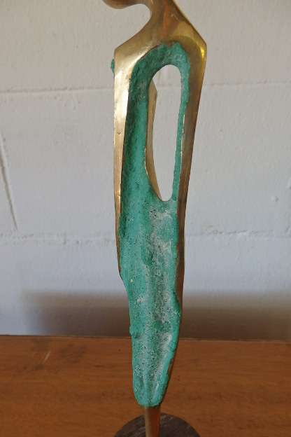 A wonderful tall solid brass abstract figurine mounted on a wooden base in great condition