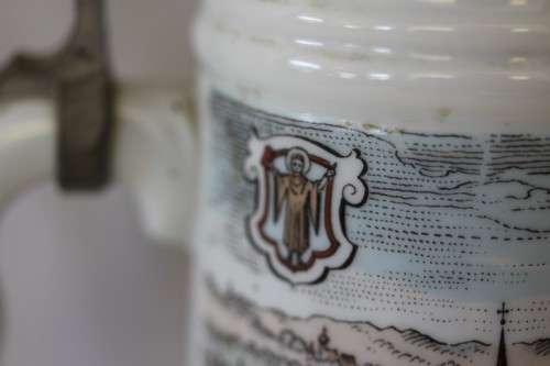 An awesome vintage white German made ceramic (lidded) Stein with "Munich" related transfer prints