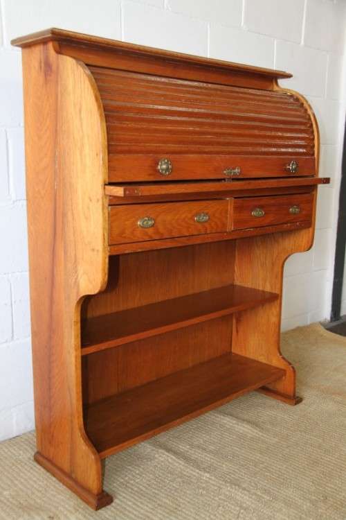 An incredible vintage solid oak roll top writing bureau with pull out writing top - very compact!