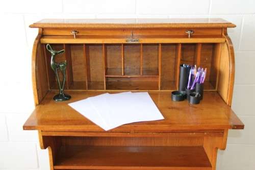 An incredible vintage solid oak roll top writing bureau with pull out writing top - very compact!