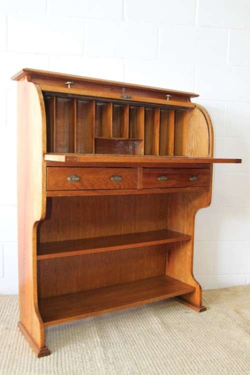 An incredible vintage solid oak roll top writing bureau with pull out writing top - very compact!