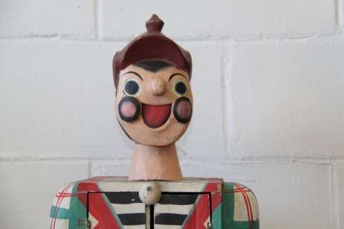 An interesting and unusual free standing antique tabletop cabinet in the form of a clown w/ shelves