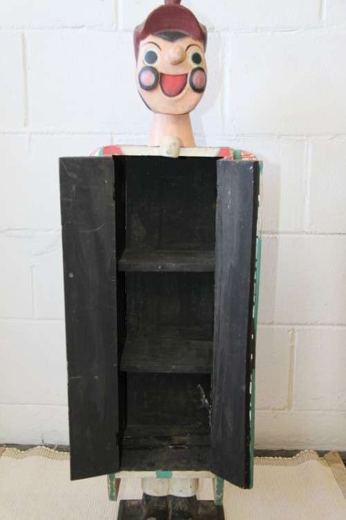 An interesting and unusual free standing antique tabletop cabinet in the form of a clown w/ shelves