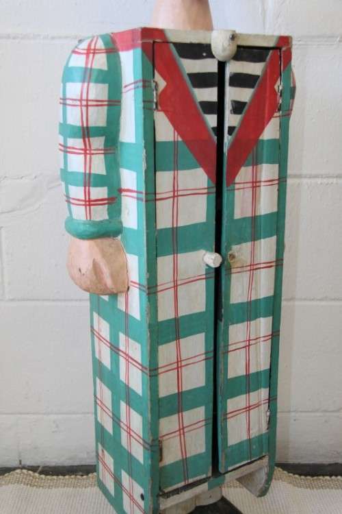 An interesting and unusual free standing antique tabletop cabinet in the form of a clown w/ shelves