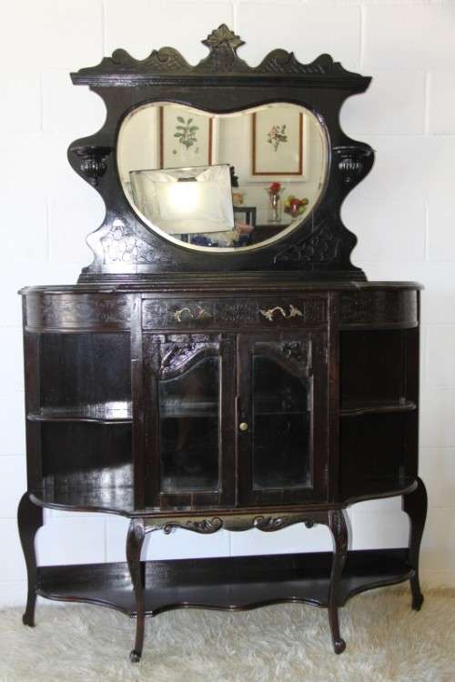 A magnificent display cabinet with a beveled mirror, cupboards and loads of shelf space