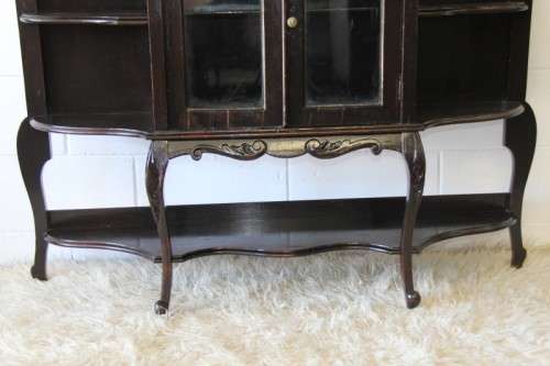 A magnificent display cabinet with a beveled mirror, cupboards and loads of shelf space