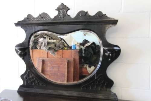 A magnificent display cabinet with a beveled mirror, cupboards and loads of shelf space