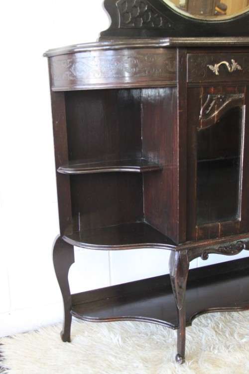 A magnificent display cabinet with a beveled mirror, cupboards and loads of shelf space
