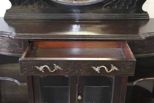 A magnificent display cabinet with a beveled mirror, cupboards and loads of shelf space