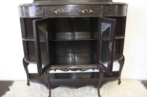 A magnificent display cabinet with a beveled mirror, cupboards and loads of shelf space