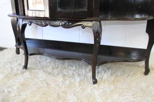 A magnificent display cabinet with a beveled mirror, cupboards and loads of shelf space