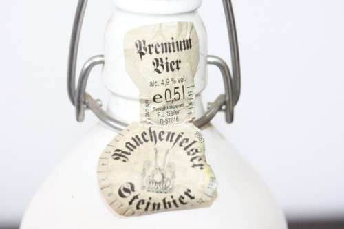 An awesome vintage German "Rauchenfelser Steinbier" porcelain Xmas commemorative flip-top decanter