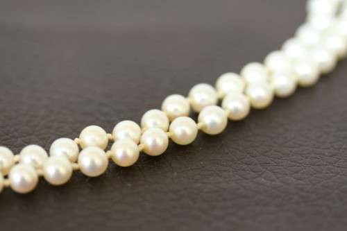A spectacular double-strand pearl necklace with a sterling silver engraved clasp & pearl earrings