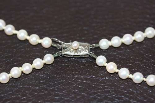 A spectacular double-strand pearl necklace with a sterling silver engraved clasp & pearl earrings