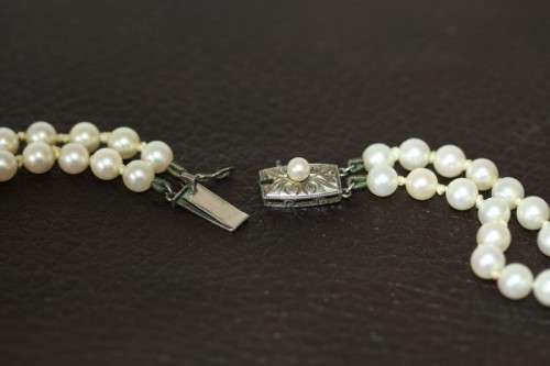 A spectacular double-strand pearl necklace with a sterling silver engraved clasp & pearl earrings