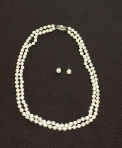 A spectacular double-strand pearl necklace with a sterling silver engraved clasp & pearl earrings