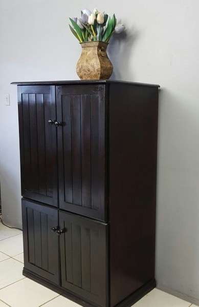 A wonderful dark stained four-door TV entertainment unit with ample space for components
