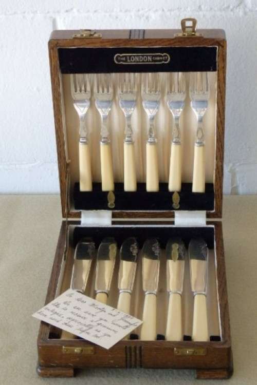 A stunning vintage bone handle style "fish knife and fork" set in its original wooden canteen